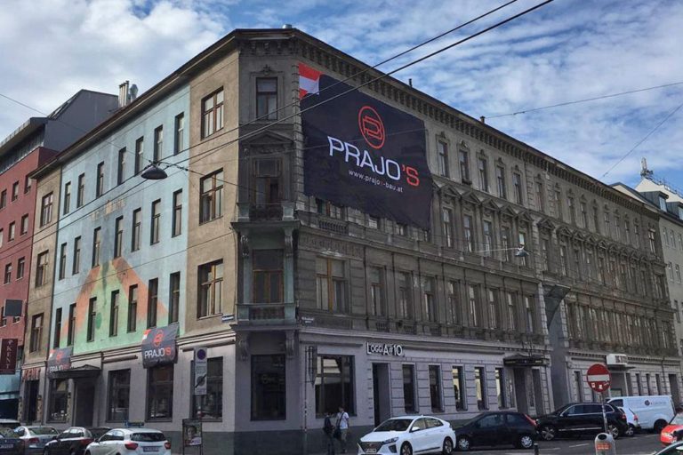 Gründerzeithaus in der Gudrunstraße/Humboldtgasse, Plakat einer Abrissfirma, Dekor, Autos, Leitungen