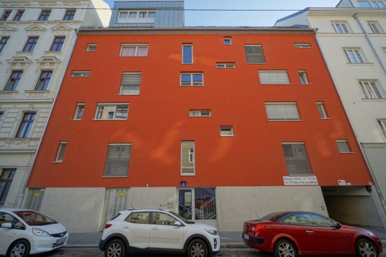 Wohnhaus mit orangener Farbe und willkürlich angeordneten Fenstern in der Schweidlgasse 18, Volkert- und Alliiertenviertel, 2. Bezirk, Wien