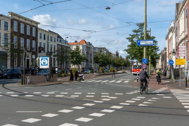 breite Straße mit Radwegen und Bäumen