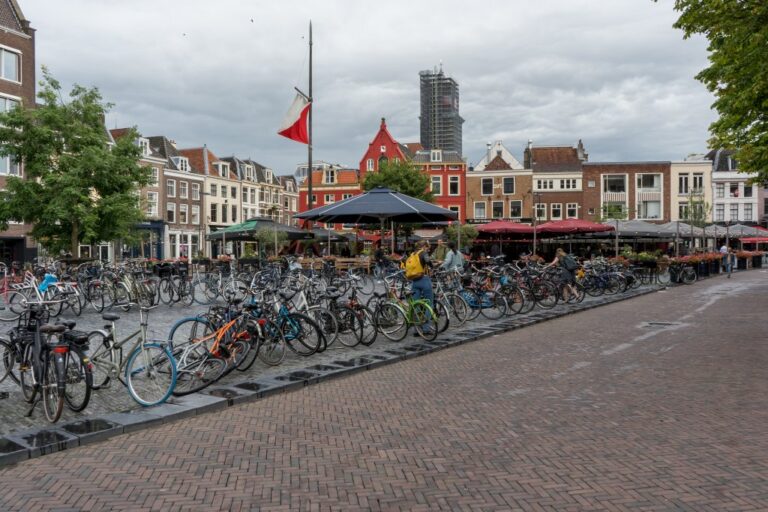 Platz in Utrecht mit abgestellten Fahrrädern und eingerüstetem Kirchturm im Hintergrund